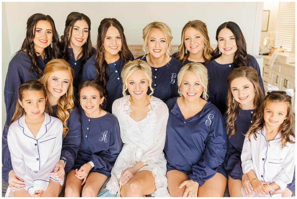 White wedding cake decorated with green and gold on a rose gold tablecloth